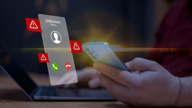 Hand håller mobil med extraherad bild av skärmen som visar okänt samtal, med varningstrianglar runtom.